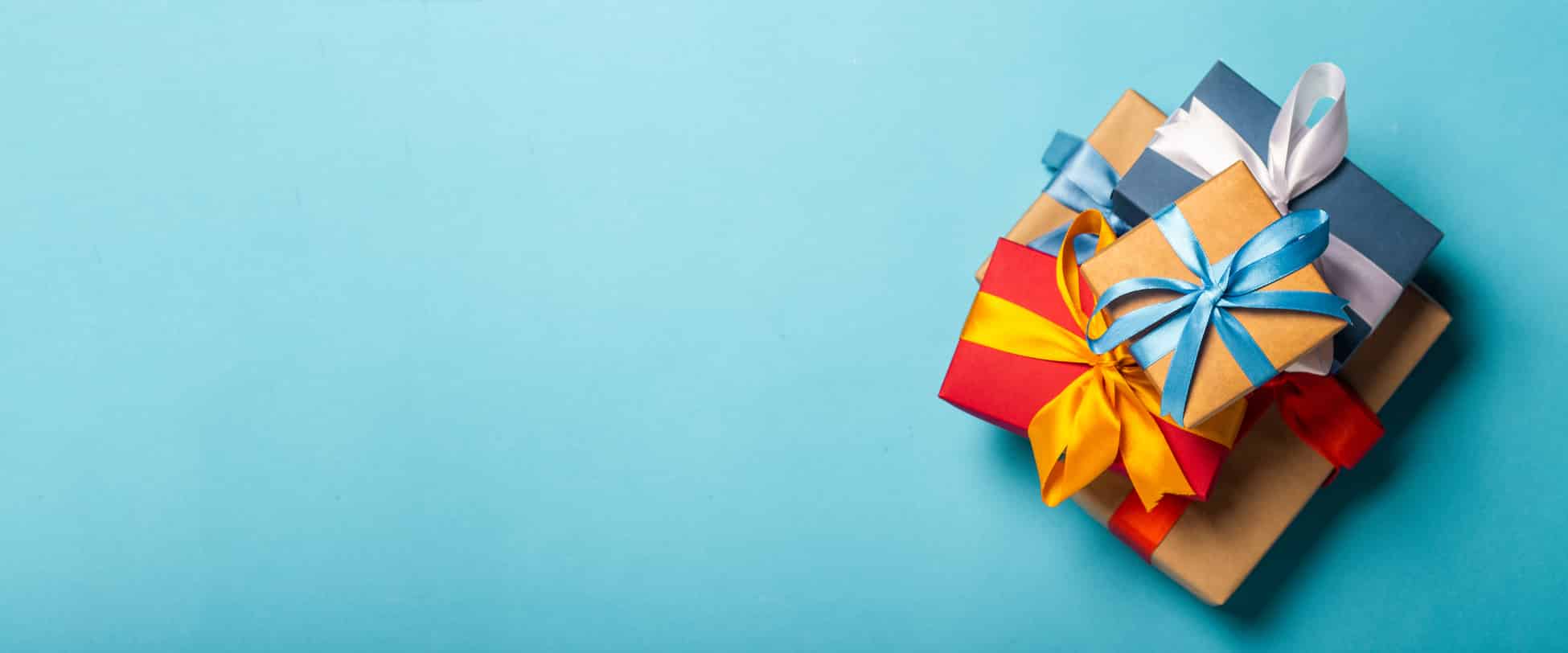 Stack of gifts on a blue background. Gift concept for a loved on Birthday Special Months-Botox Near Me